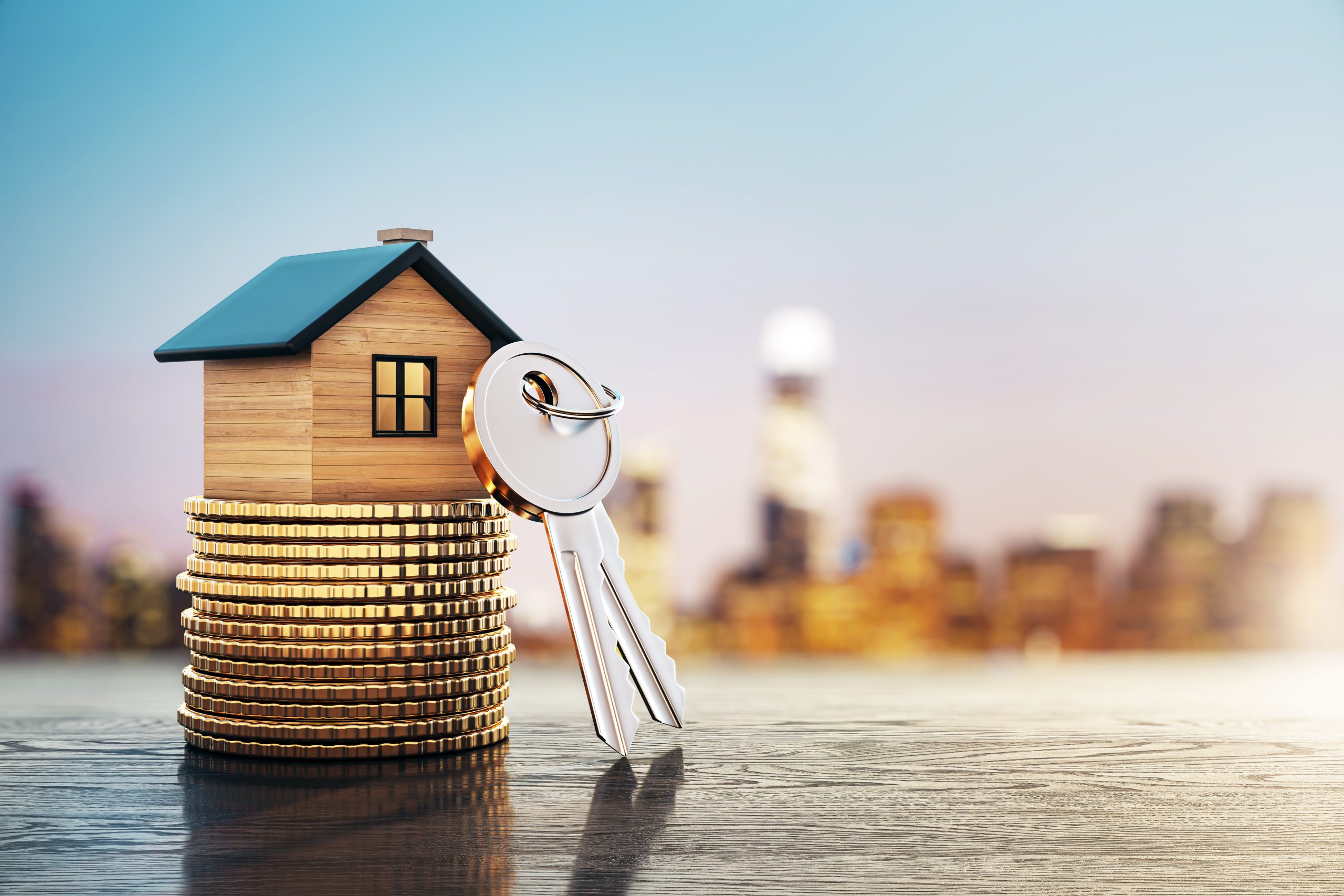 Miniature house on coin stacks with keys